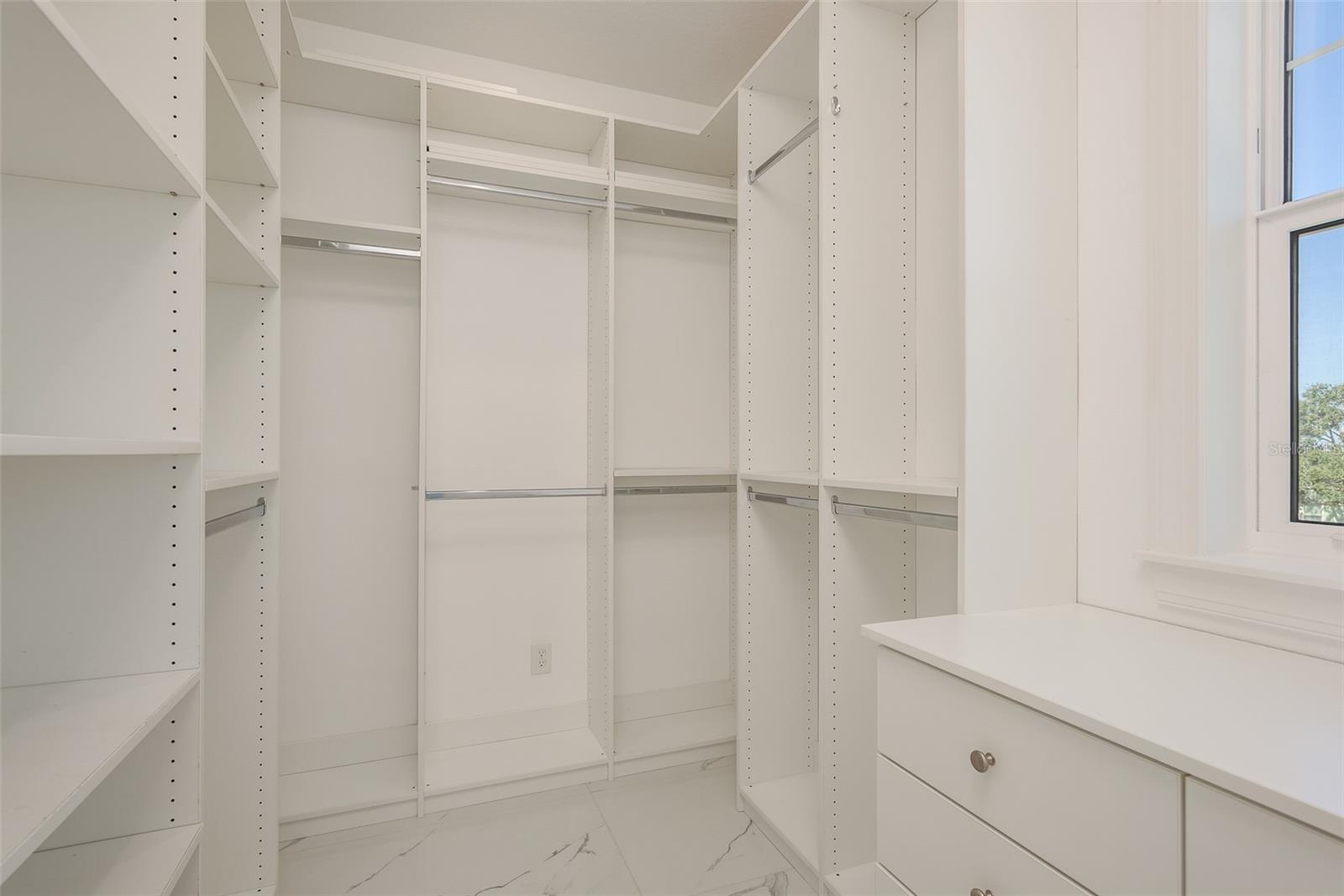 Revel in the impressive walk-in closet, complete with custom built-ins.