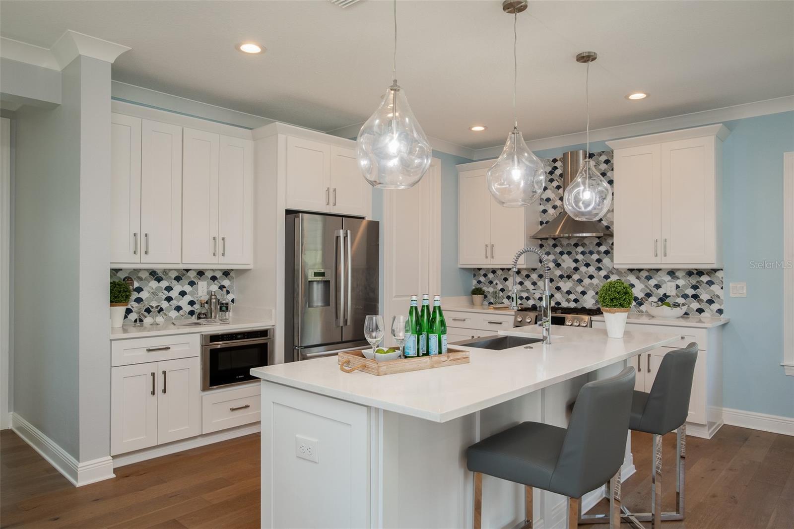 Indulge in the luxury of opulent quartz countertops and top-of-the-line Stainless Steel Bosch appliances, transforming every culinary endeavor into a masterpiece in the heart of your coastal haven.