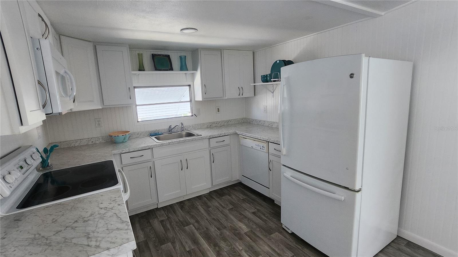 Bright and clean workable kitchen with over the stove built in microwave and new garbage disposal