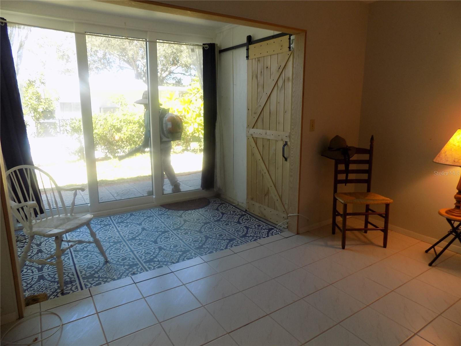 Enclosed Sunroom Porch - and Laundry Closet.  New Storm rated Sliding doors to Patio area.