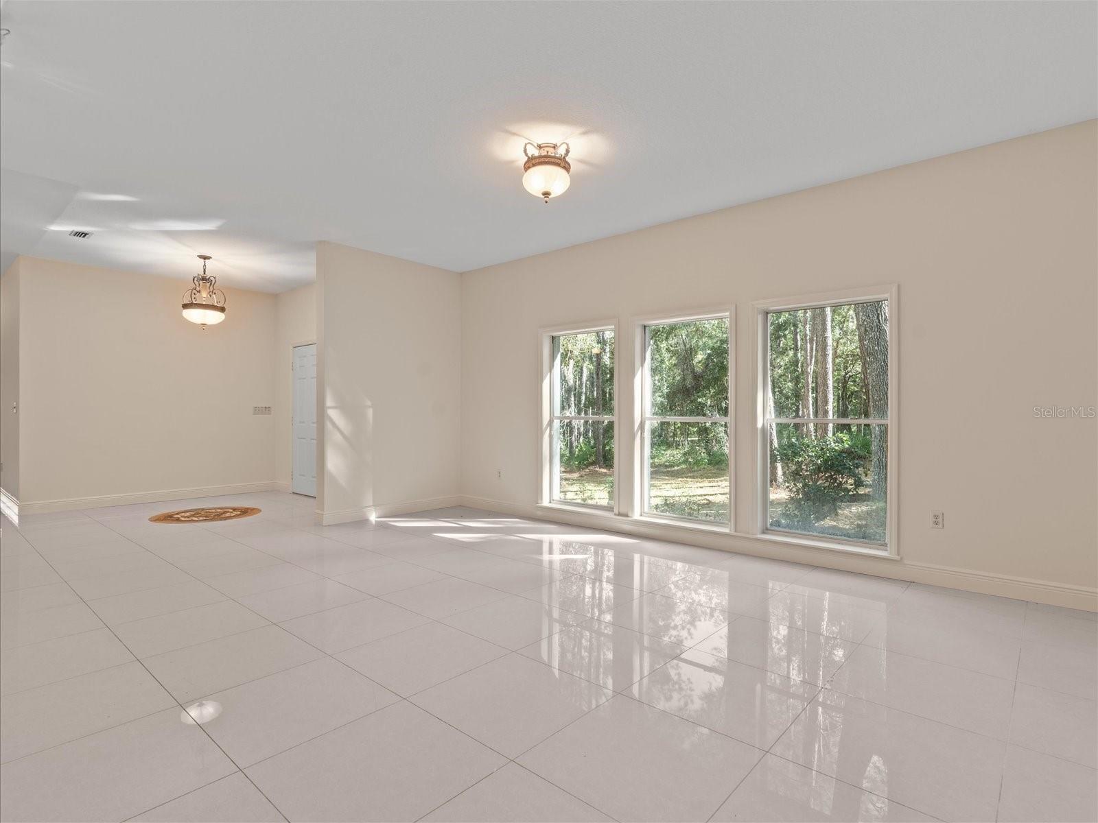 Formal Dining Room with elegant flooring and natural light streaming from the front