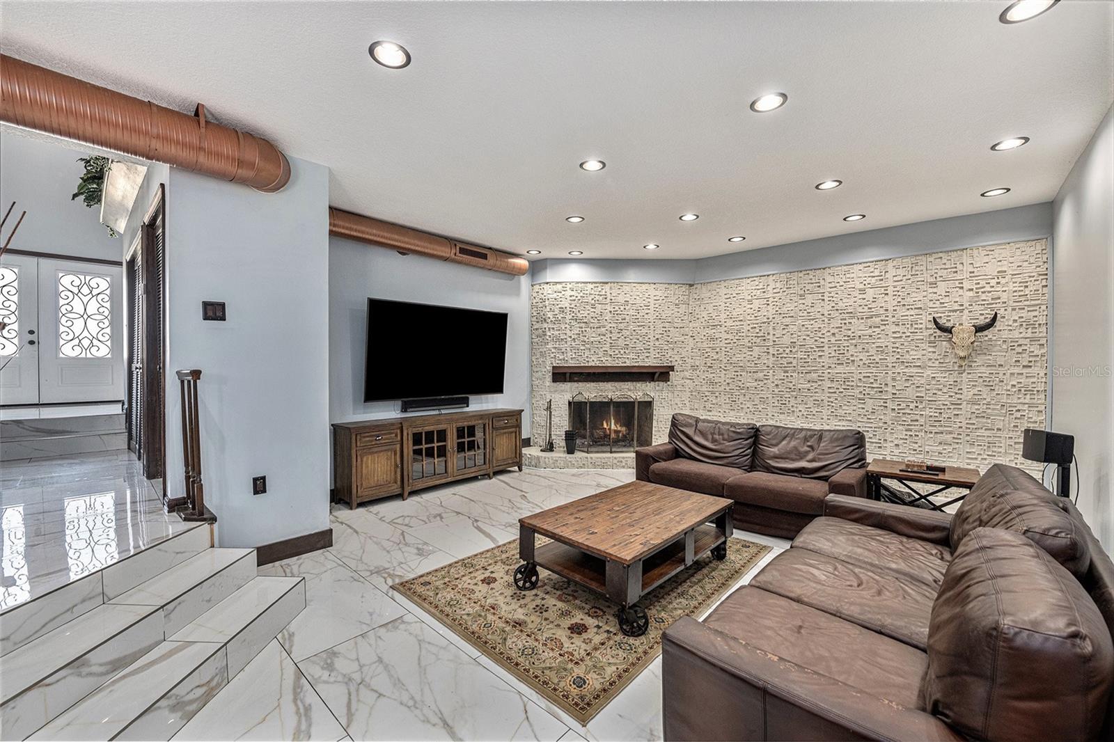 Family room with stone accent wall and fireplace