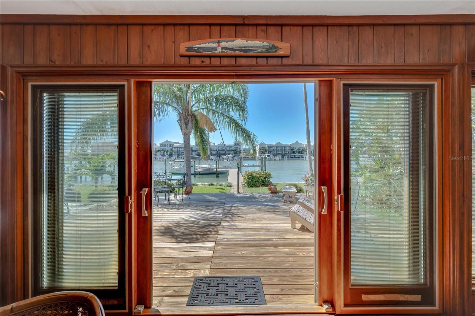 Doors from great room to deck, large back yard and dock beyond...
