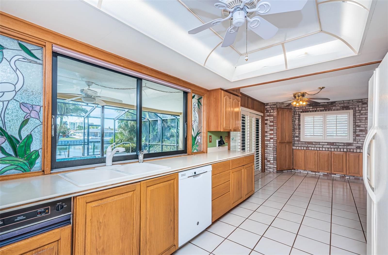 A strategically placed window offers a delightful view of the outdoor oasis while you cook.