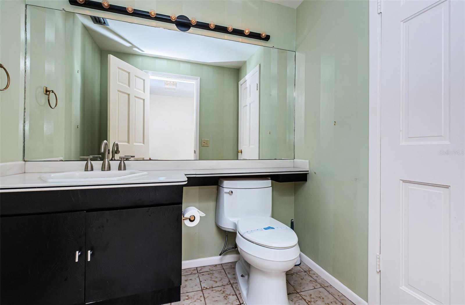 Experience the convenience of this thoughtfully crafted powder room, making it a delightful addition to the charm of this home.