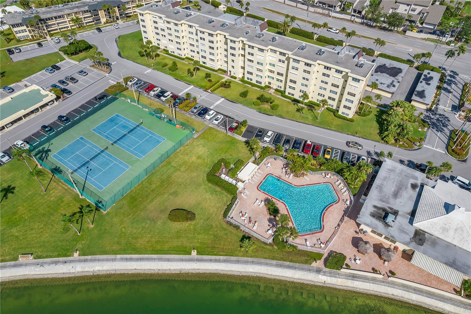 Ariel shot of the tennis court & clubhouse pool.