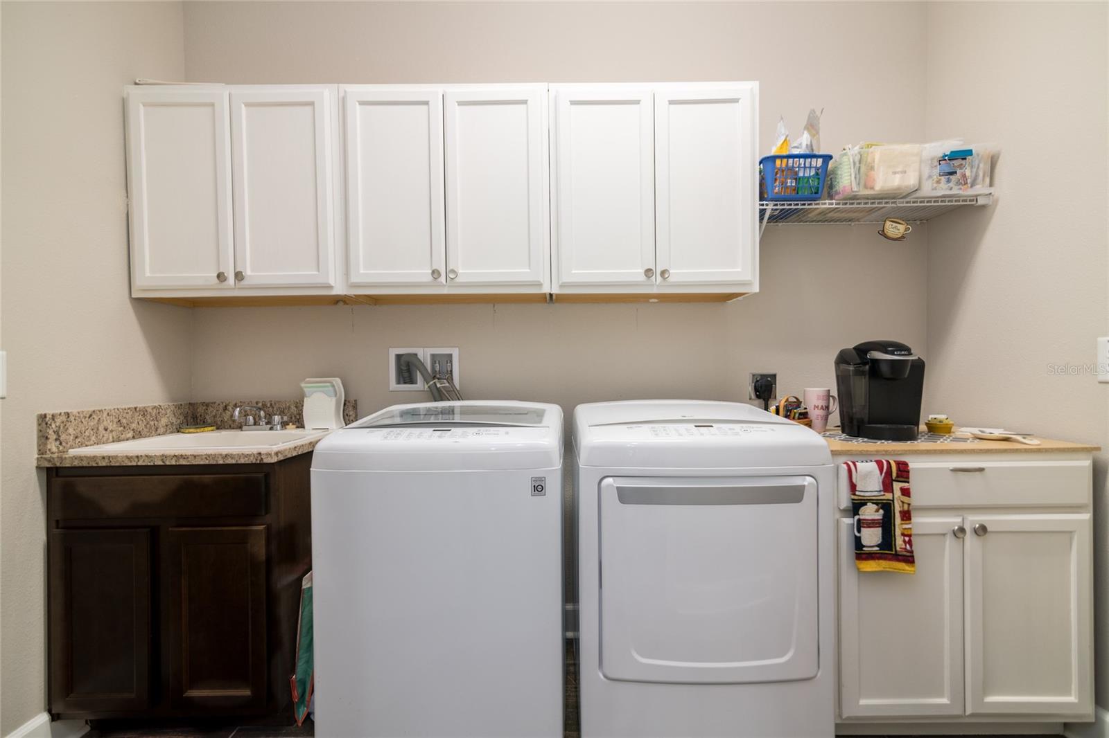 Laundry room is inside with sink and coffee bar