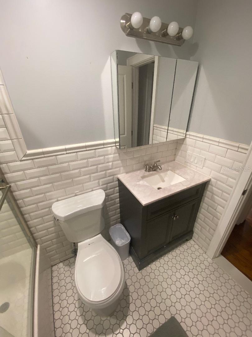 Newer Vanity with Tile Walls in Guest Bathroom