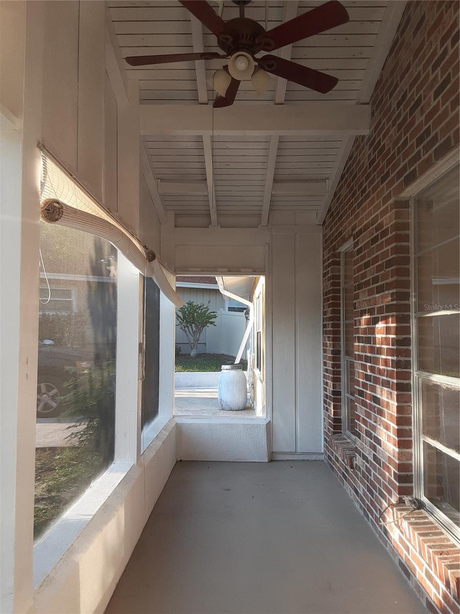 enclosed front porch with new paint from ceiling to floor for you to enjoy sunrise and sunset