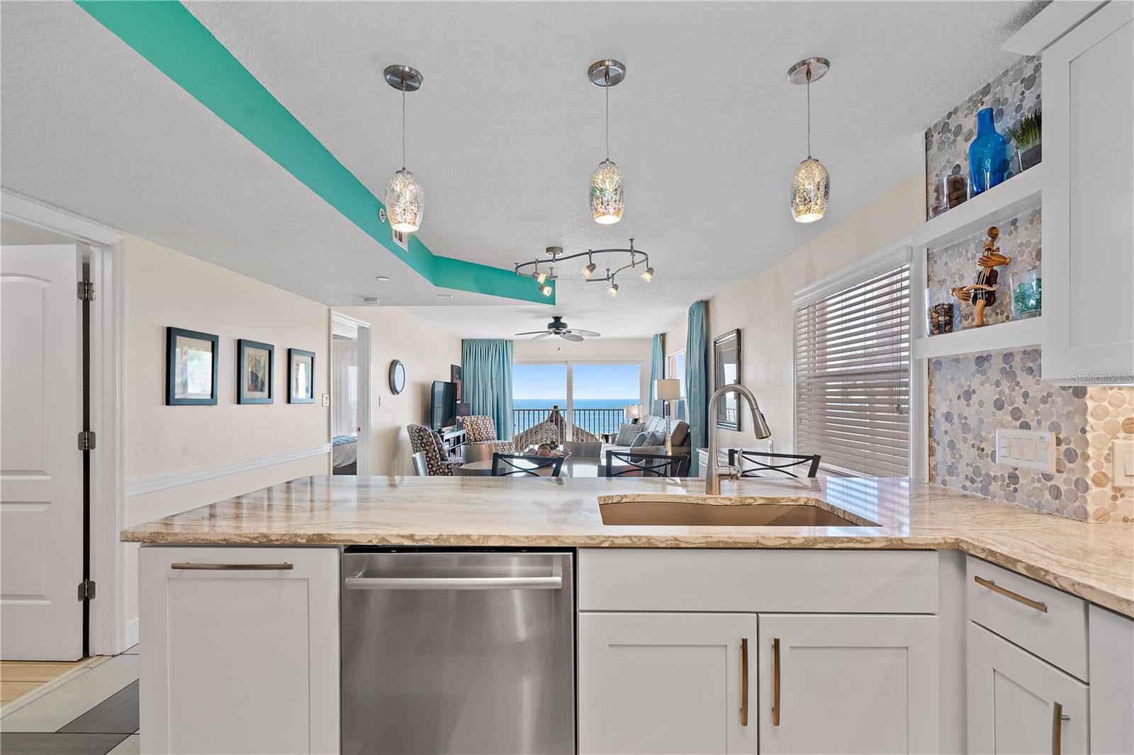 View the raised ceiling and overview of the common area and water when standing at the sink.