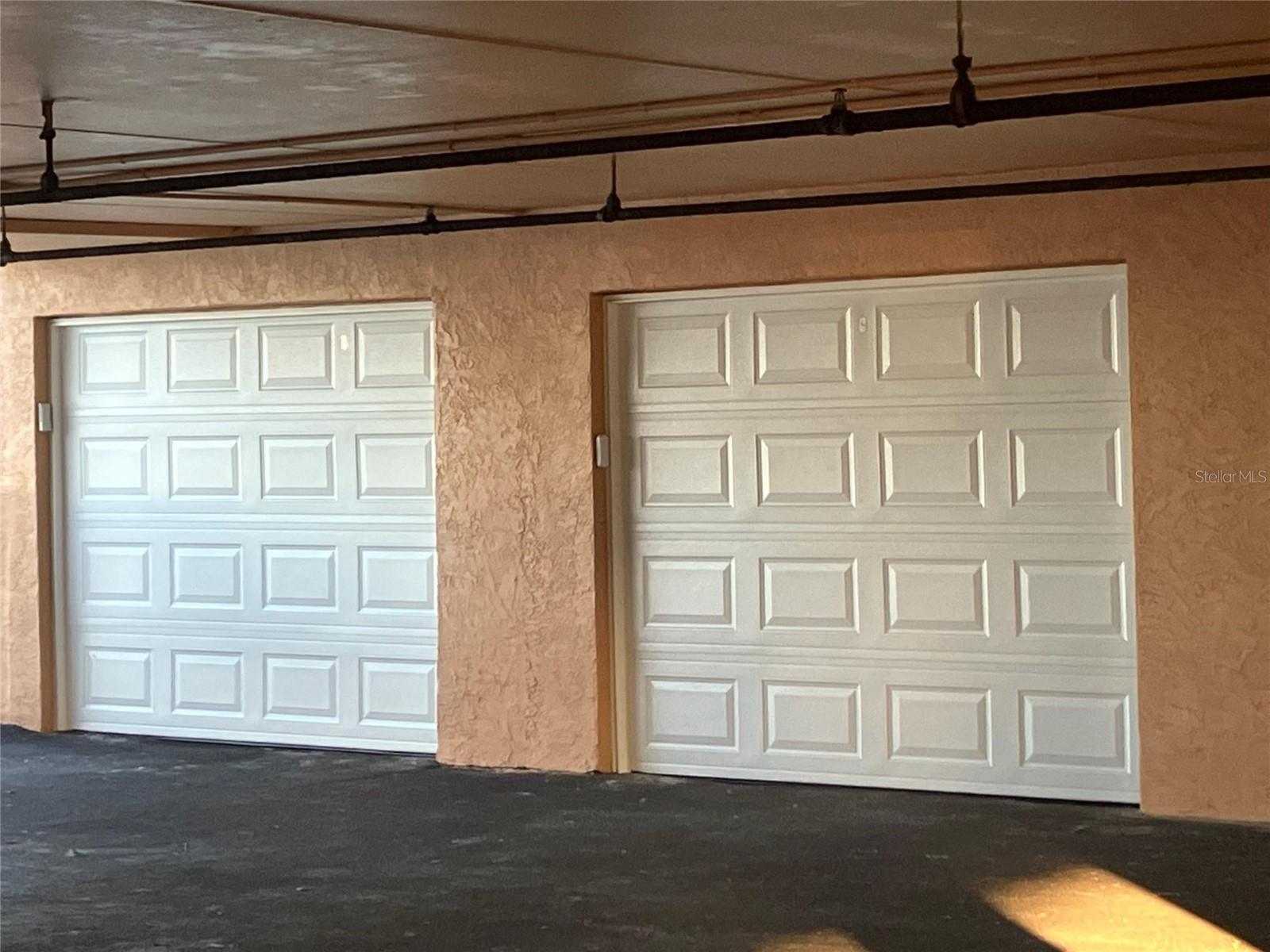 The garage to the left in this photo comes with the purchase. 11" x 25'.  (Brand new door.)  Currently, there is room for two kayaks on the wall mount, refrigerator, beach chairs, storage -- and still room for an automobile.  The garage can fit a car and golf cart at the same time.  Can be leased and shared or reserve it for your use only.  On the coast, it is uncommon, virtually rare, for a condo to have a private garage.
