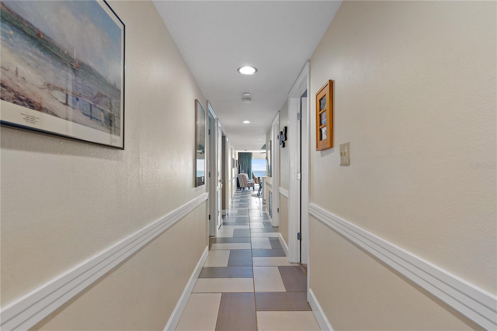 The entrance hall creates a great first impression with attractive tile patterns, chair rail, and direct access to bedrooms two and three as well as the laundry room. It is bright and cheery.