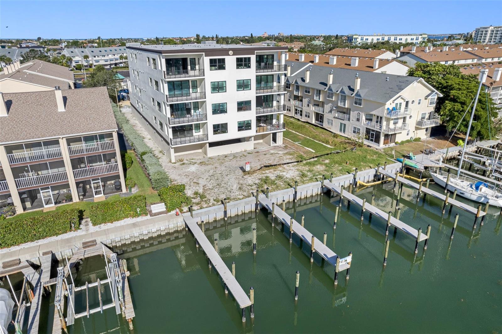 The boat slips are 50' long. 12' width without a boat lift. 10.4' with a boat lift. Electricity can accommodate up to a 35,000 lb boat lift. The land between the boat dock and building will be a tropical pool and lanai oasis.