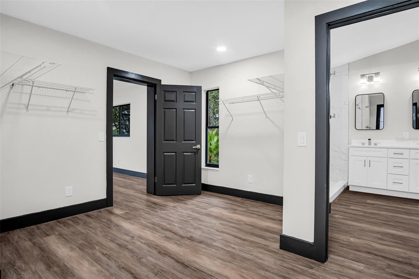 Master closet with view into office and master bathroom