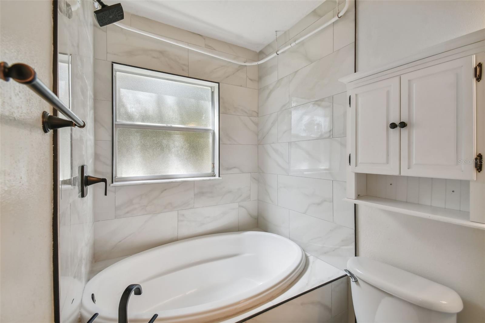 Tub and shower combo with lovely porcelain tile