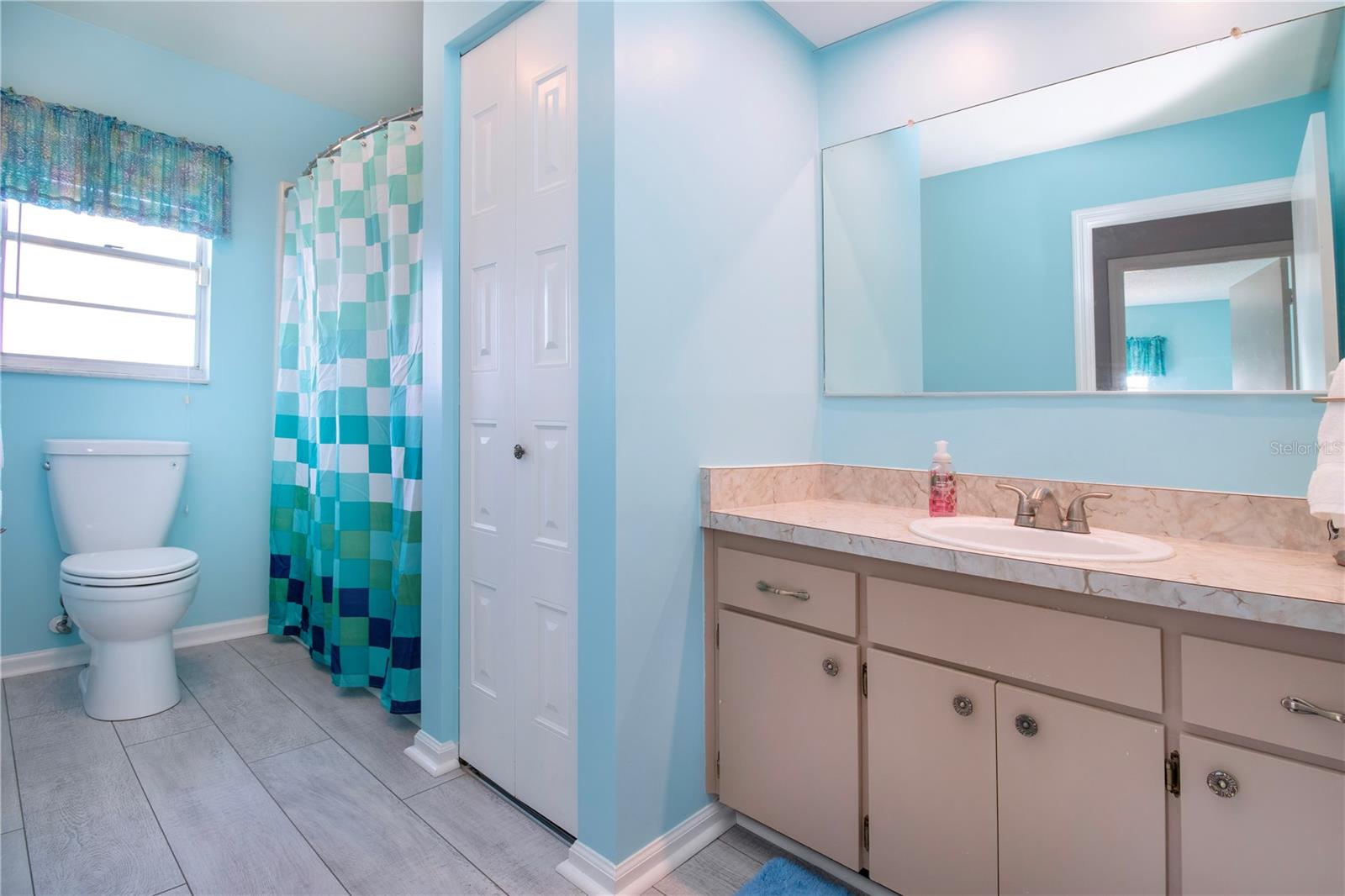 Hall bathroom, New LVP flooring, shower/tub, linen closet