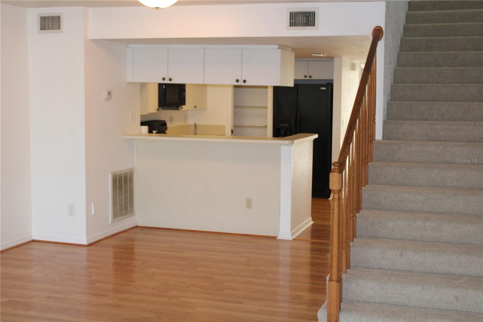 Kitchen and dining area with stairs to third floor