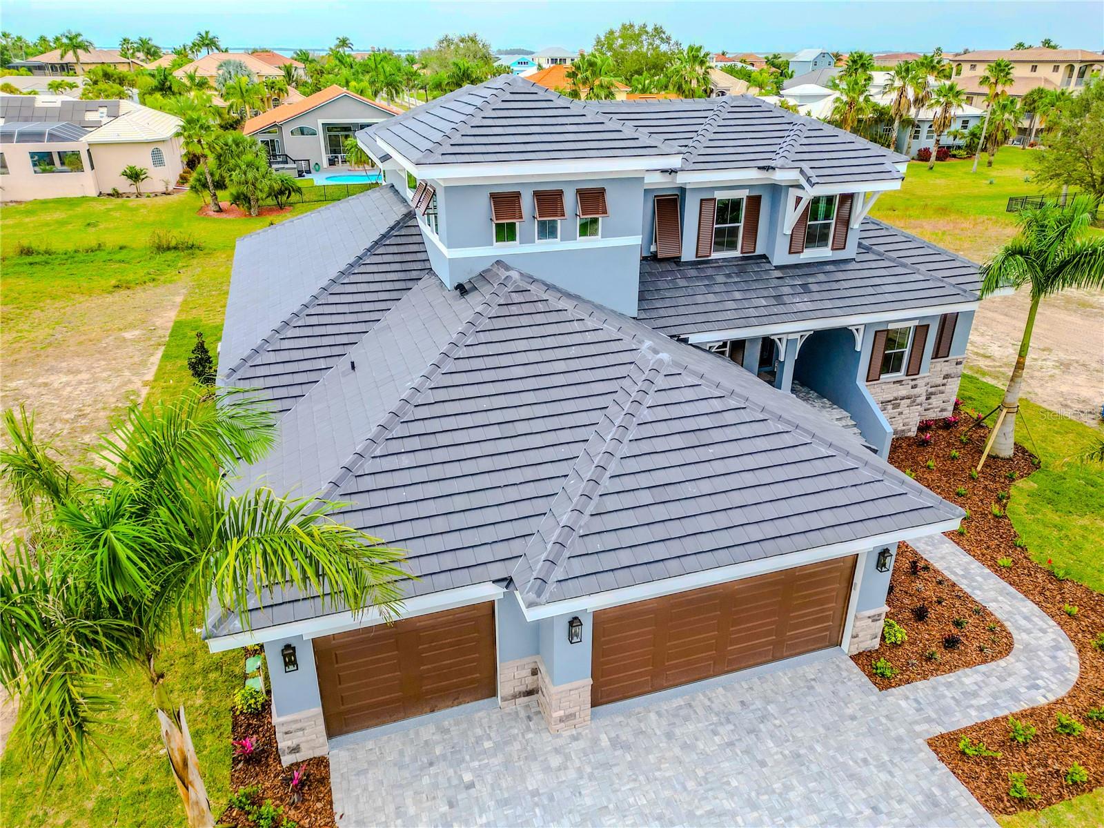 Details like the Bahama Shutters, Gabled roof line and Exterior Corbels add to the overall grandeur of this home.