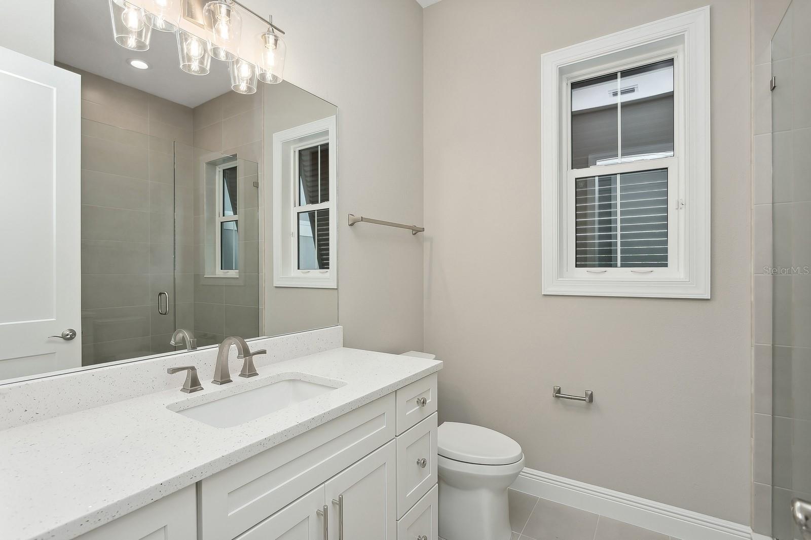 All baths have wall tile to ceilings and framless glass doors.
