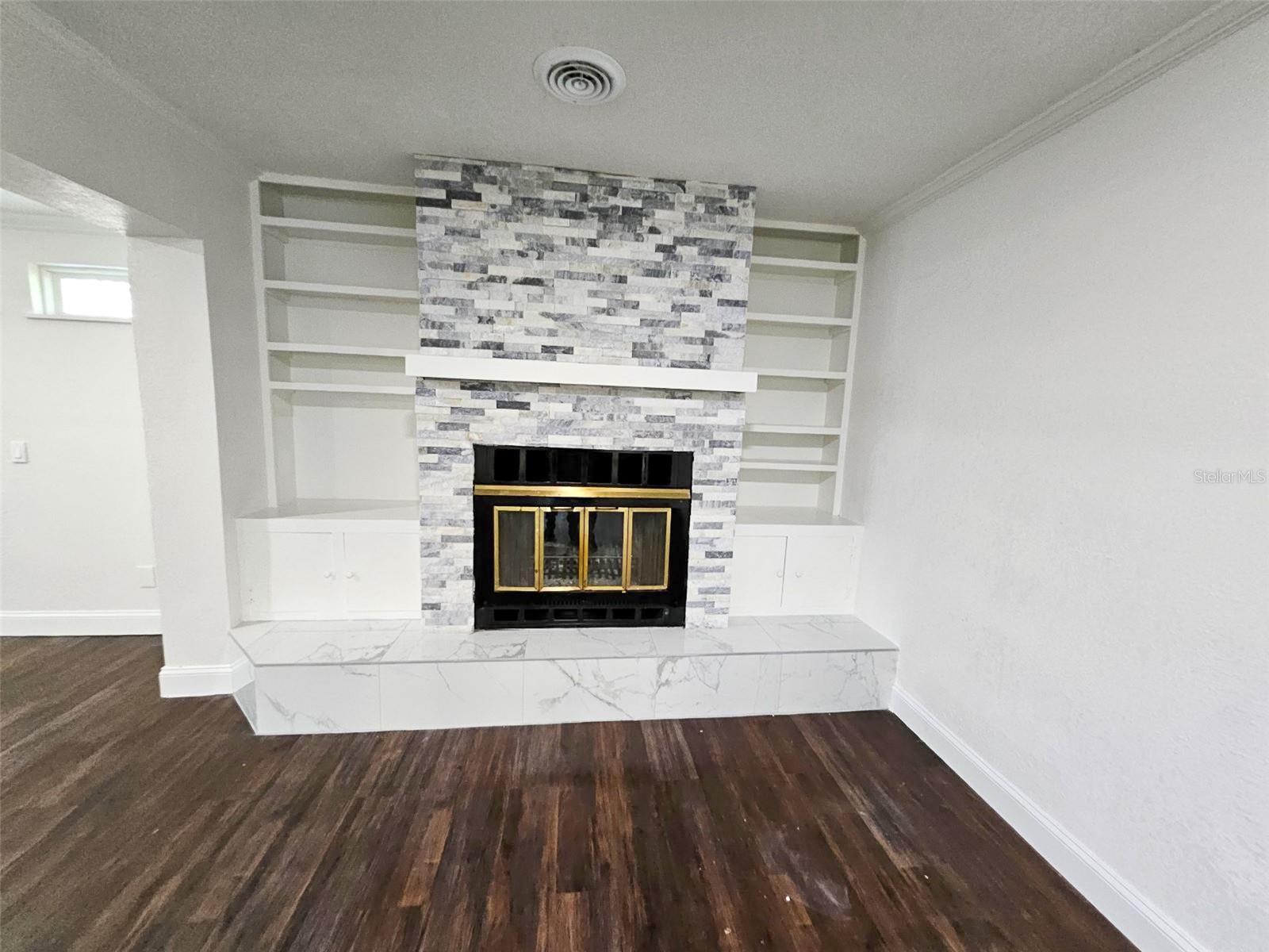 Beatiful Stone Fireplace flanked by shelving