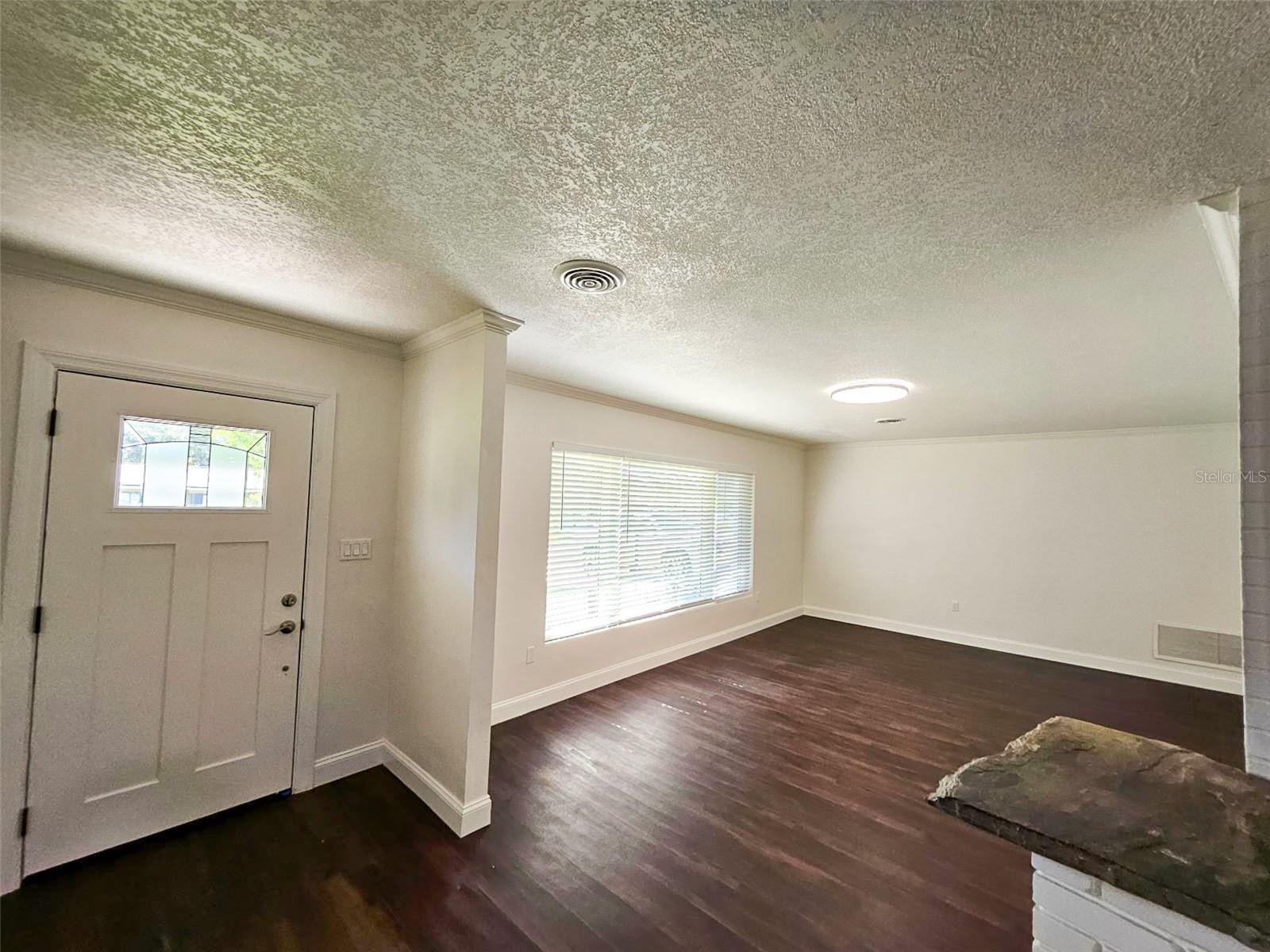Entry with a large front room that could be a nice office or living room