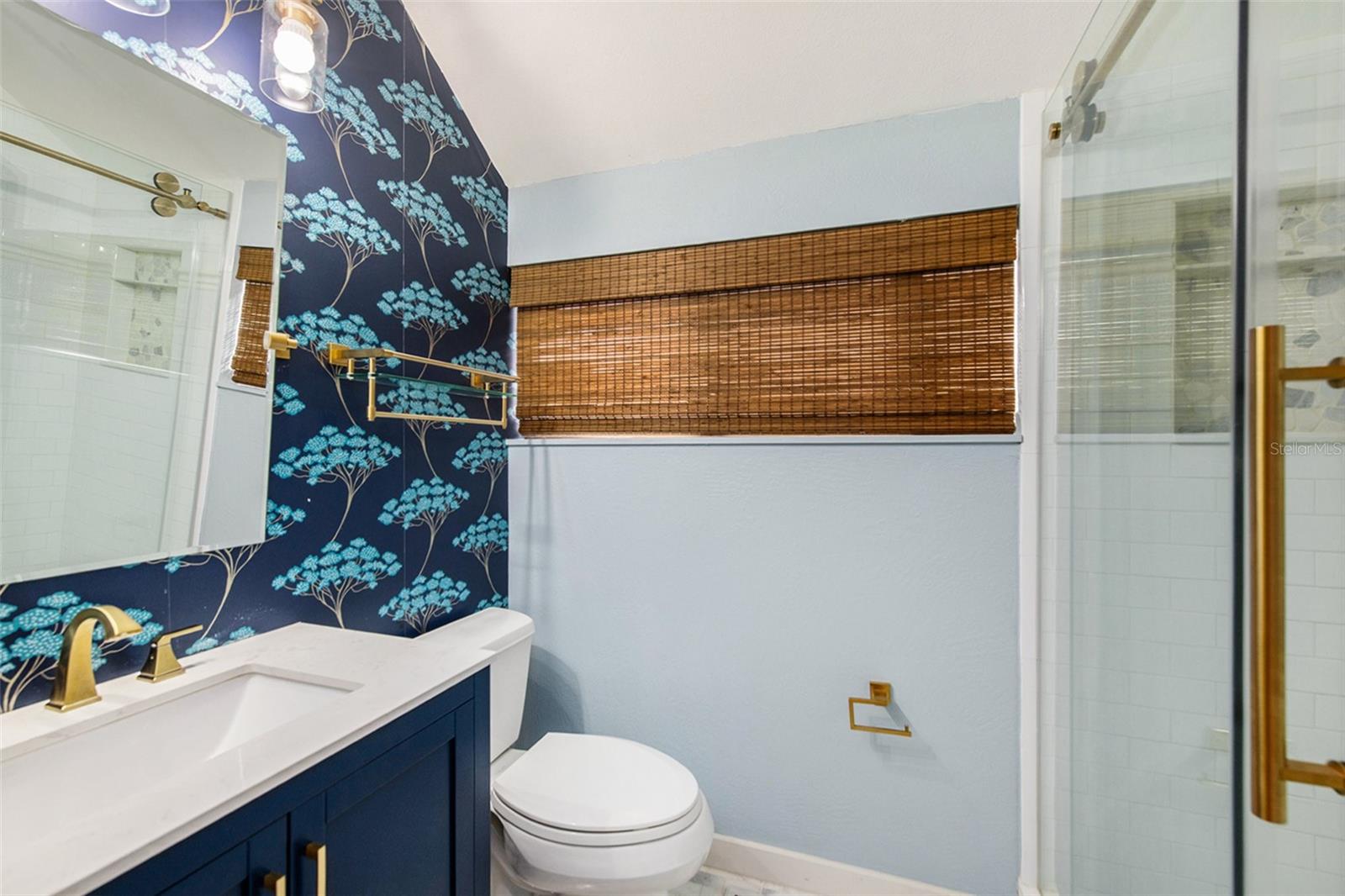 2nd bathroom in upstairs loft features updated fixtures and a gorgeous accent wall