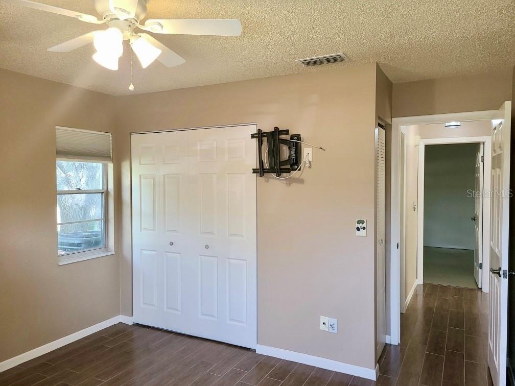 2nd Bedroom with wood-like tile floors and new ceiling fan