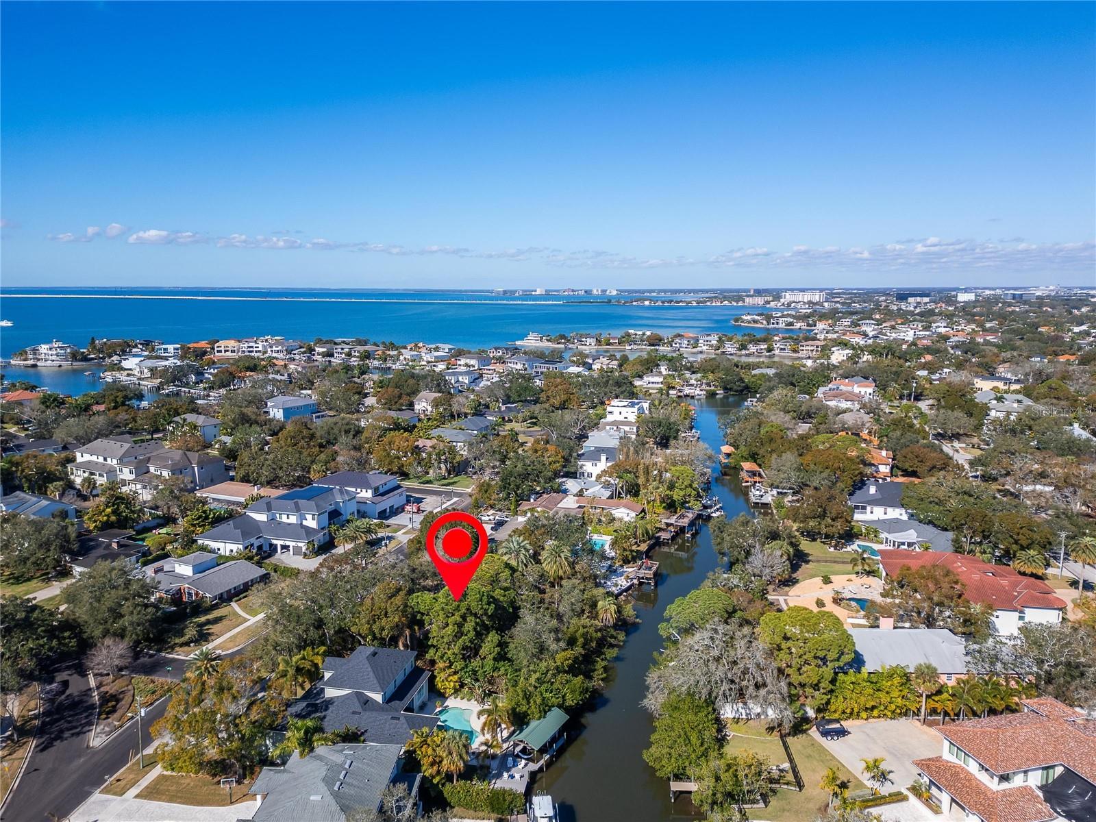 This property has direct access to the Gulf of Mexico via a short canal trip. Watch the drone video to see how quickly you can navigate to open waters. Camera faces NW in this image.