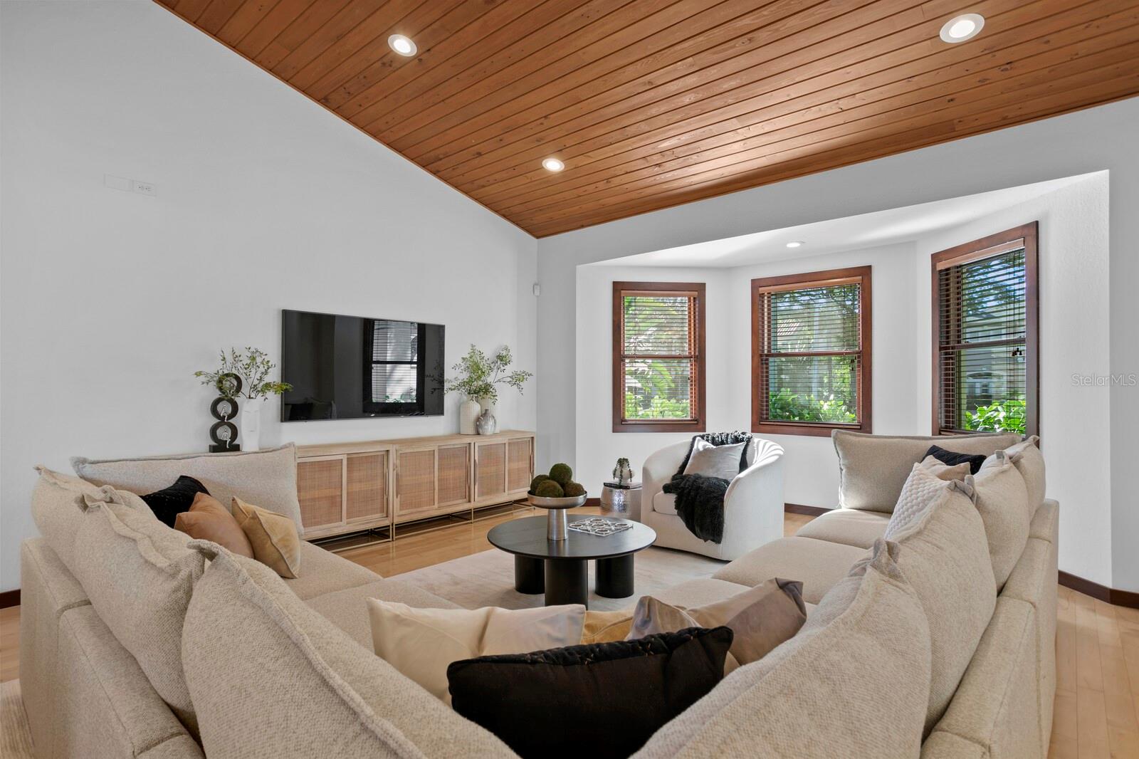 The living room features bay windows and great natural light