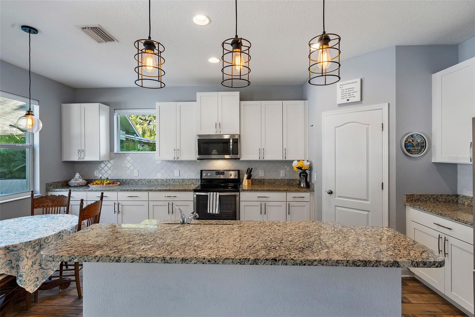 Kitchen offers granite countertops, center island, stainless appliances, and a walk-in closet pantry. Open, airy, light and bright!