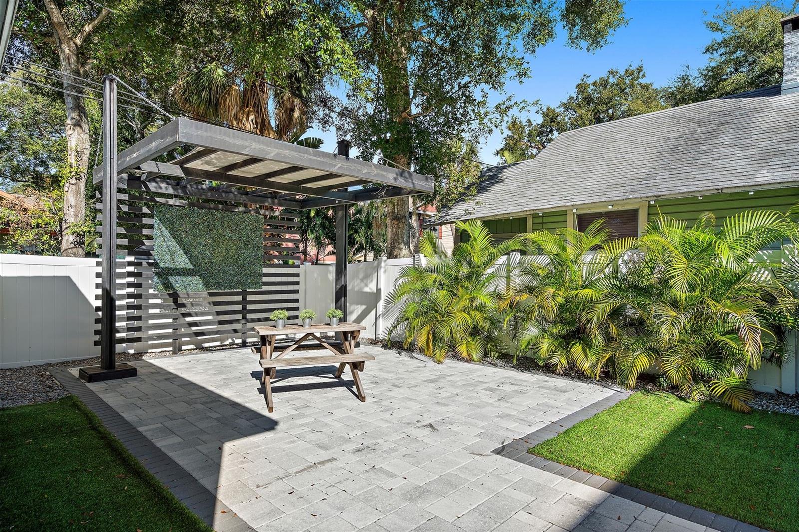 Backyard is fully fenced and has a beautiful modern pergola.