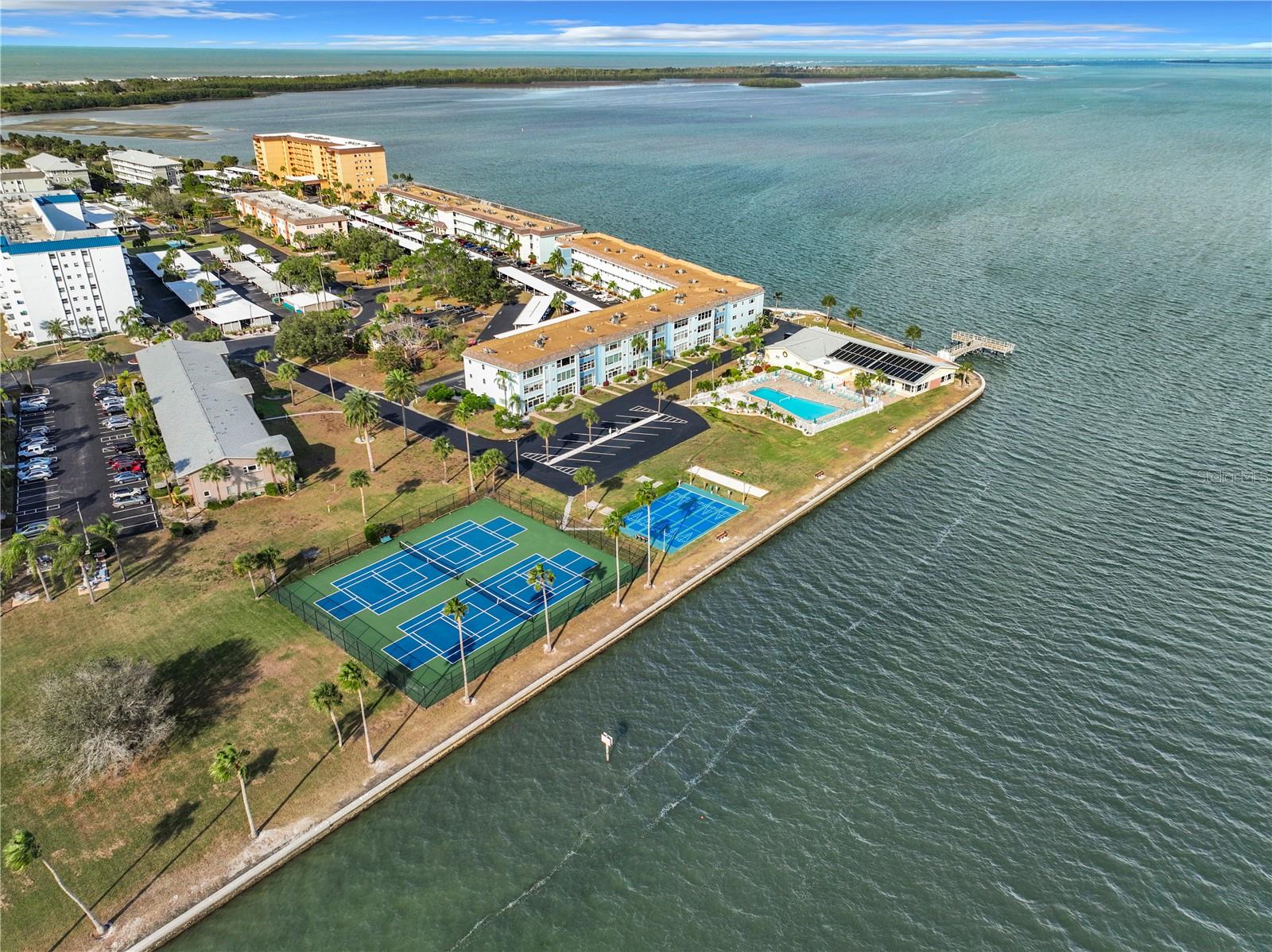 Aerial view with tennis, pickleball courts and pool