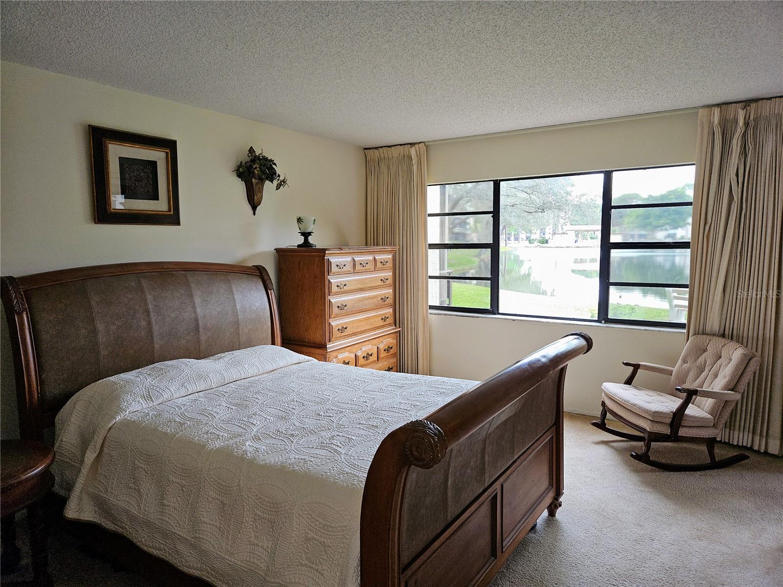 Master Bedroom With View of Peaceful Pond at Rear of the Unit