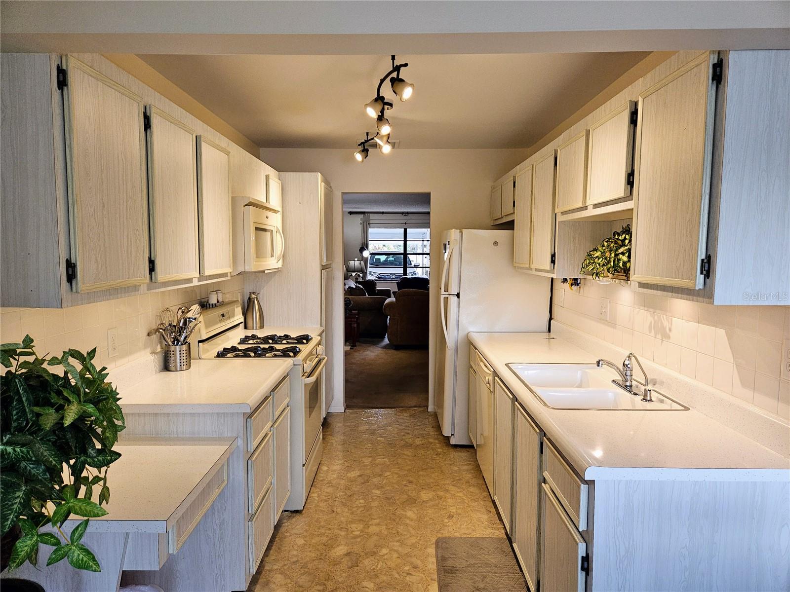 Nice Galley Kitchen Has Convenient Built-in Desk, Microwave, Dishwasher