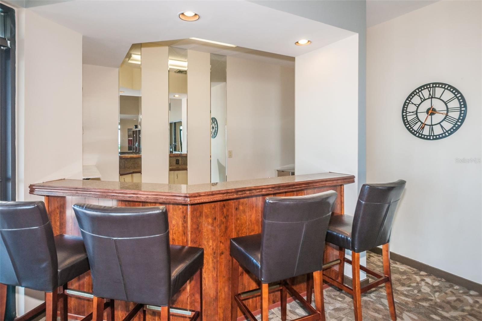 Clubroom wet bar with chairs