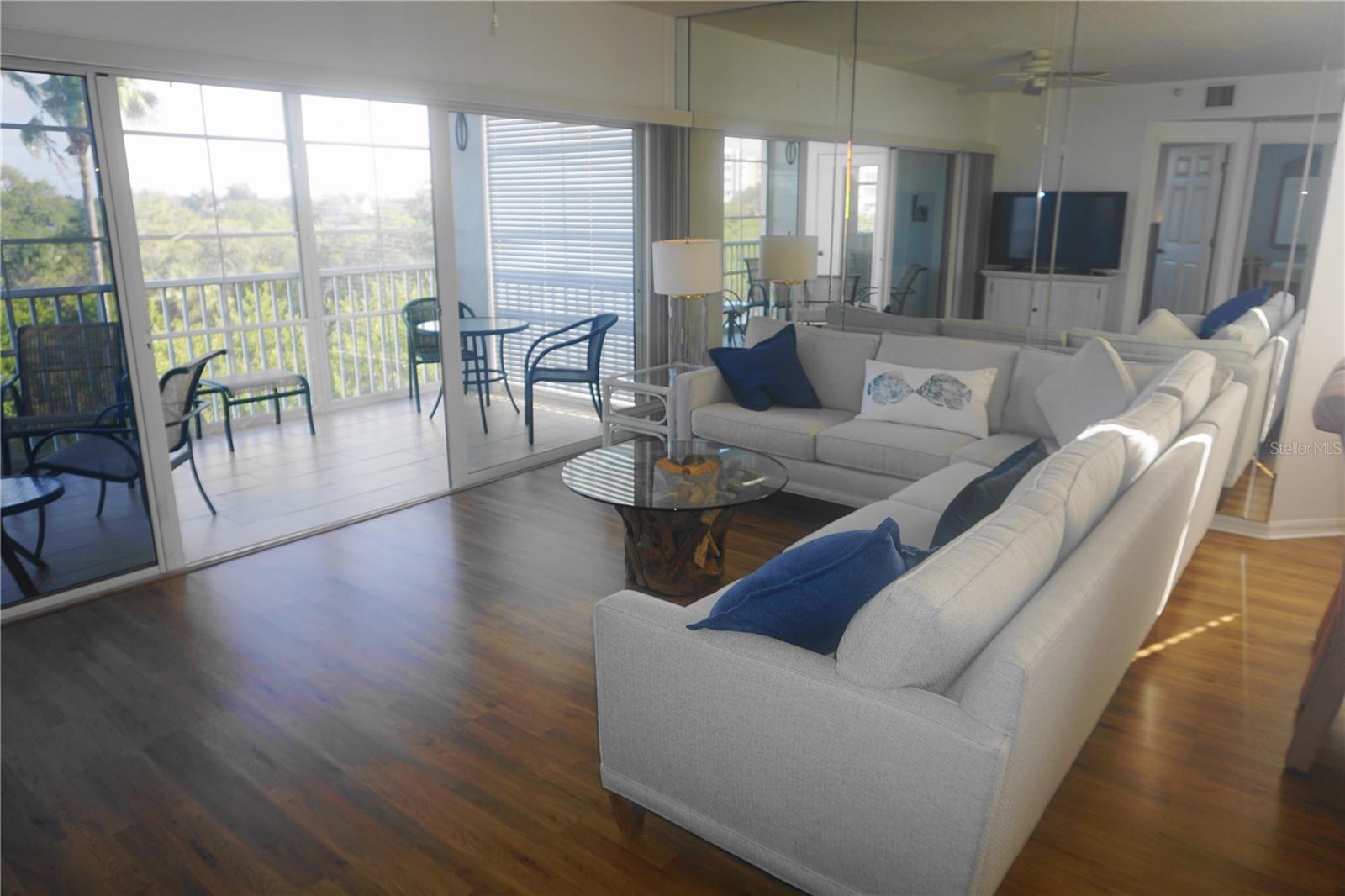 The living room with entry to the lanai overlooking the lake & bayou