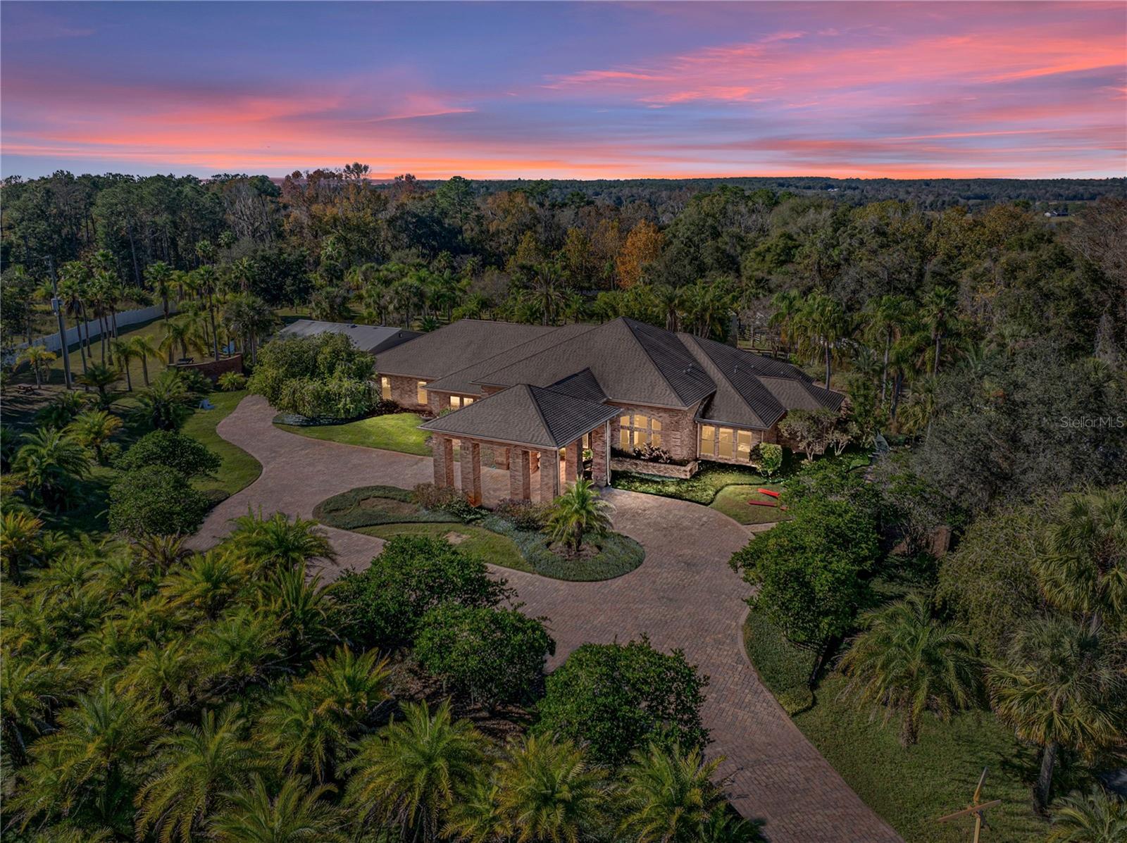 Exclusive and very private custom home with lagoon pool, hundreds of palms, separate guest home with separate entrance, 3 stocked ponds and all private fenced.