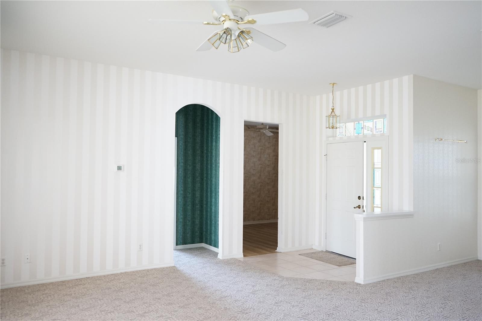 entry, den is door on right, left green hallway is to hall bath and guest bedroom