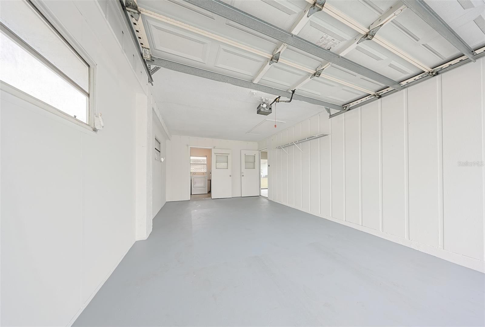 Garage, recently painted with newly applied epoxy floor finish and automatic door opener