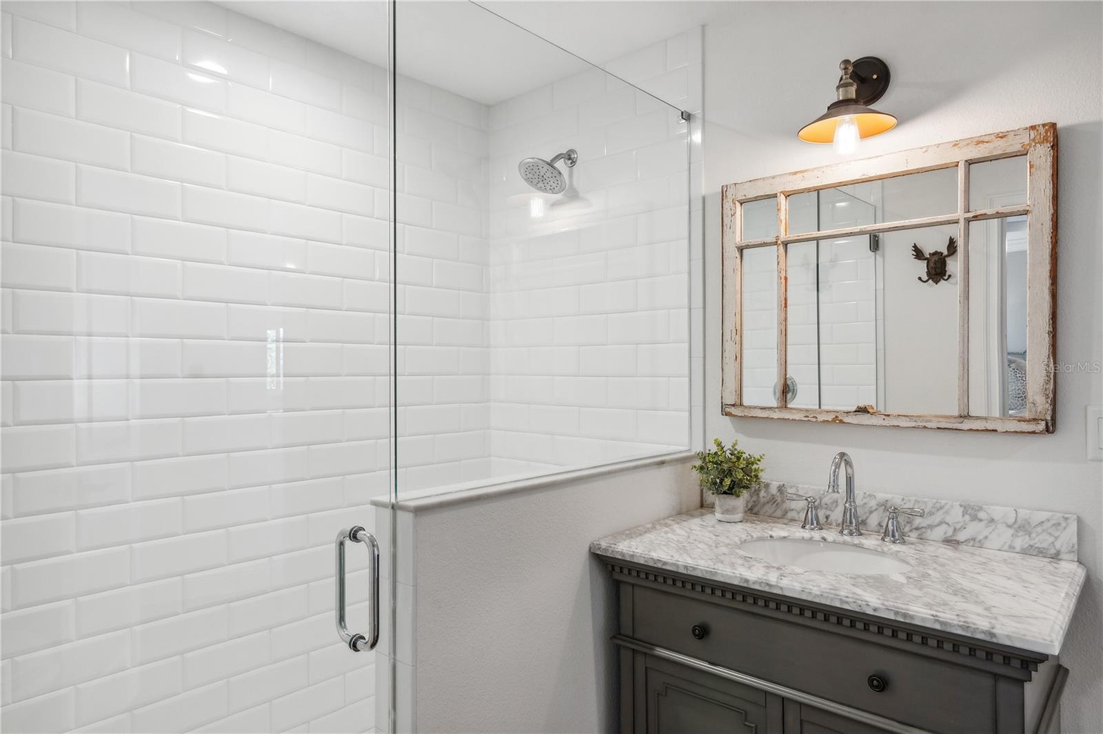 Guest bath with beautiful subway tile walk-in shower...