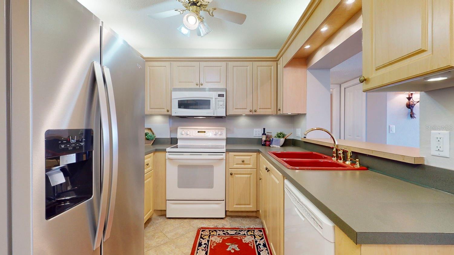 spacious and beautifully well lit kitchen with new stailness refrigerator