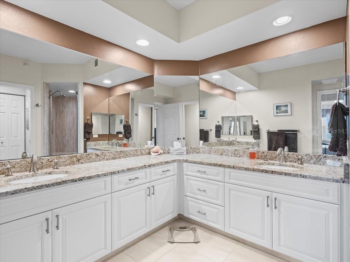 The bathroom features plenty of counter and cabinet space and includes dual vanities.