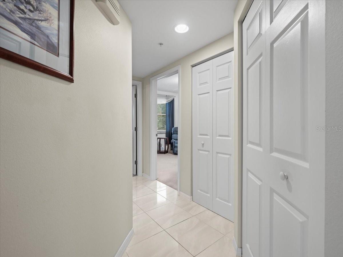 This hallway leads to two guest bedrooms, a bathroom and a pair of storage closets.