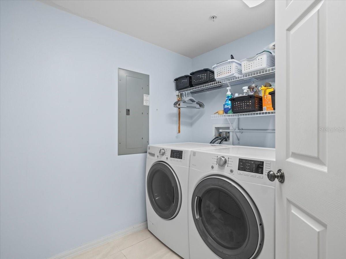Laundry Room includes side-by-side washing machine and dryer that convey with the sale.  The hot water heater and air conditioning condenser are also located in the laundry room and utility closet.