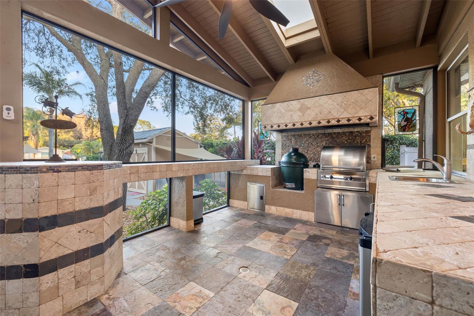 Screened outdoor kitchen with green egg smoker