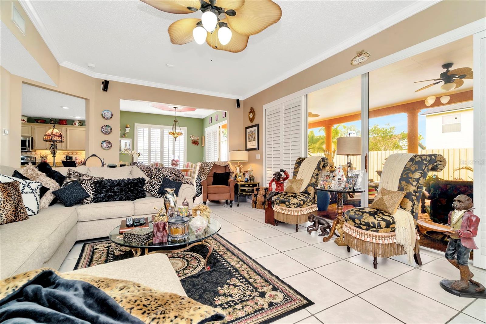 Spacious family room that has views to the pool area. Large Sliders with Plantation shutters as well. Huge upgrade!