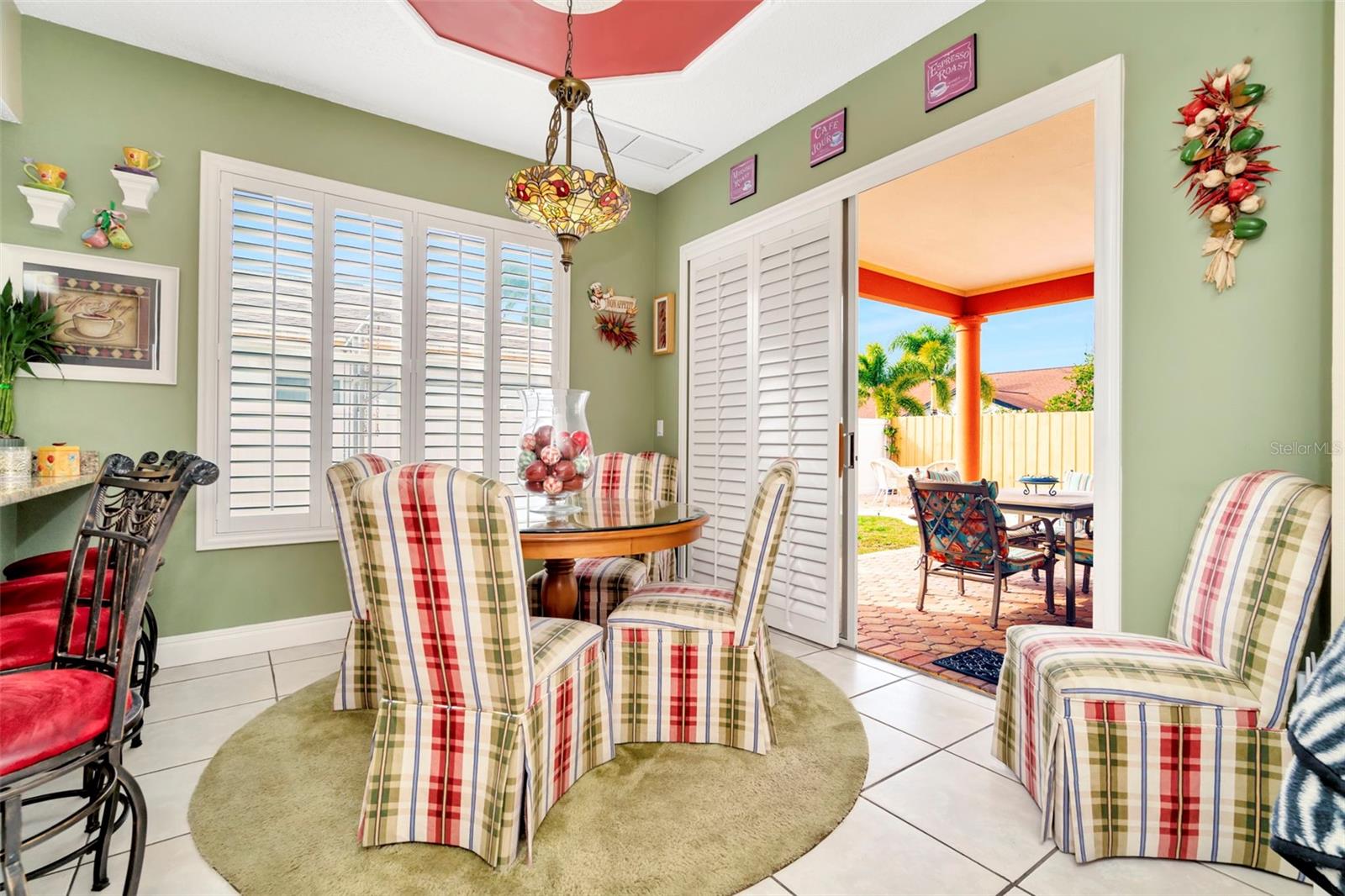 Dinette that open to Back covered porch. Notice Plantation shutter sliders