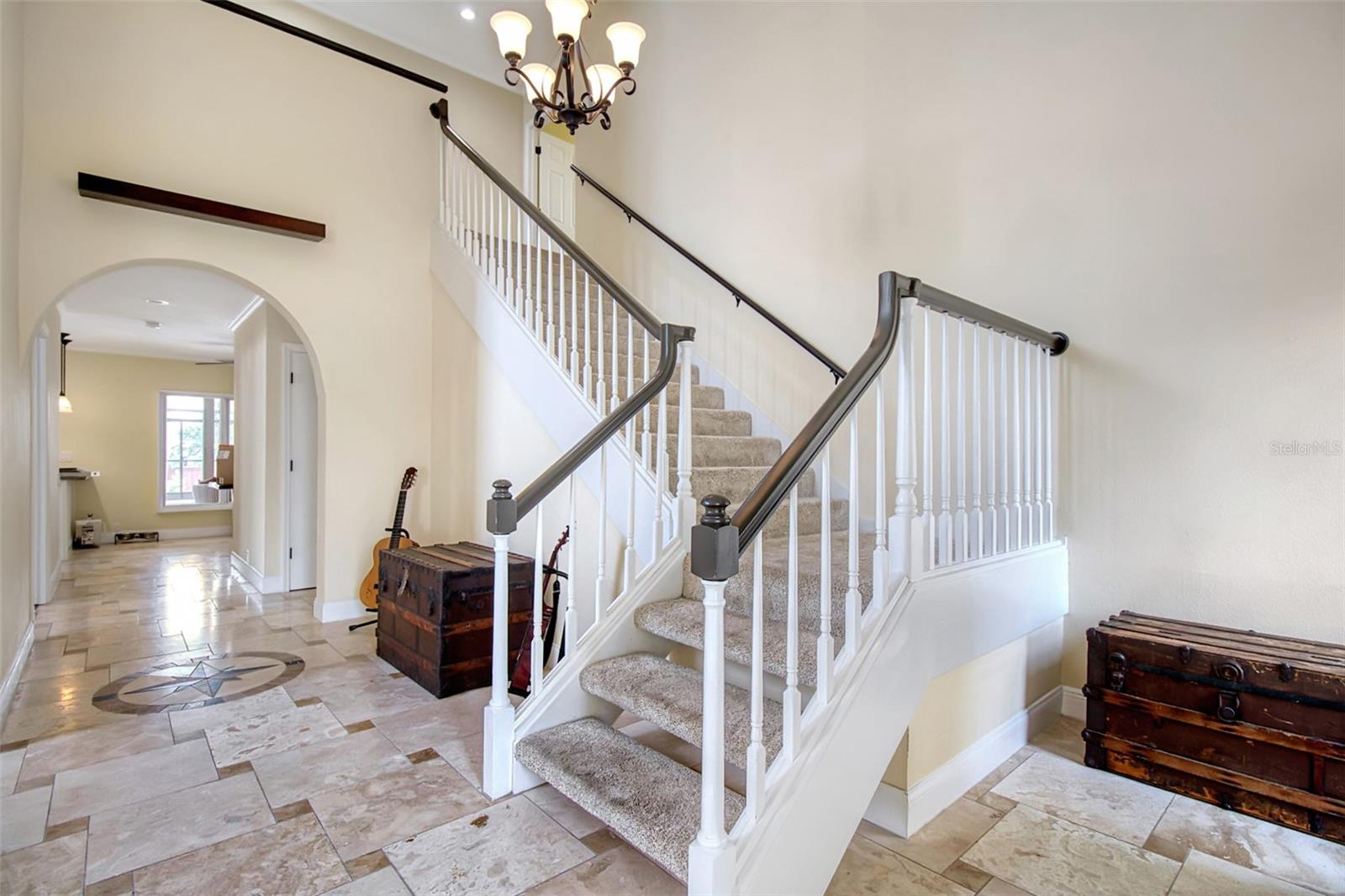 Enter home through the double front doors to the wide grand staircase and formal living room/flex space