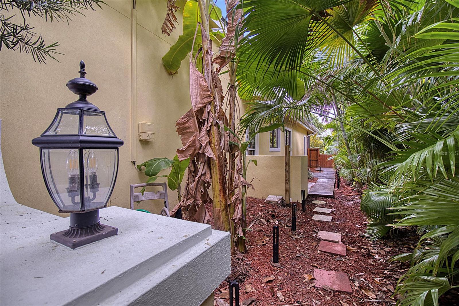 Manicured and landscaped side path leadiing to guest apartment private entrance