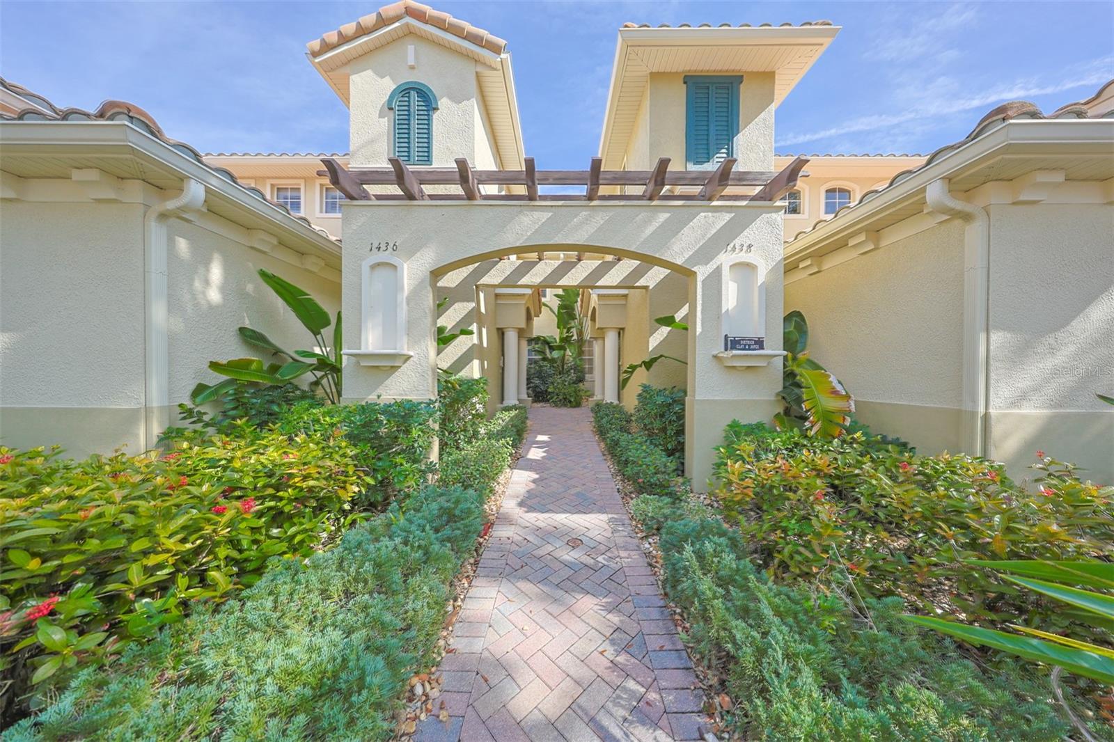 Front entrance of this WATERFRONT luxury Tuscan-style condo unit which is beautifully manicured and well maintained. Walking to the front door or up and down the street, you immediately feel the "Tuscan" vibes.